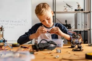 a boy enjoying STEM Funding Boost at school.